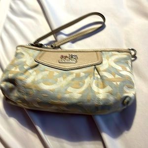 Cream/light green colored monogrammed Coach wallet wristlet